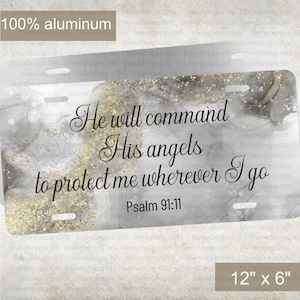 May include: Rectangular license plate made of 100% aluminum, featuring the text "He will command His angels to protect me wherever I go Psalm 91:11." The plate has a gray and gold marble design and measures 12" x 6".