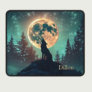 May include: A black mousepad featuring a silhouette of a howling wolf on a hilltop under a full moon. The background includes a starry sky and pine trees. The name "Dillon" is printed in gold.