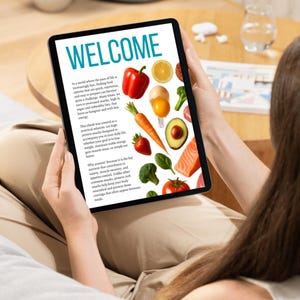 May include: A person holding a tablet displaying a colorful page with the word "WELCOME" in large teal letters. The page features images of fresh produce and text about protein snacks.
