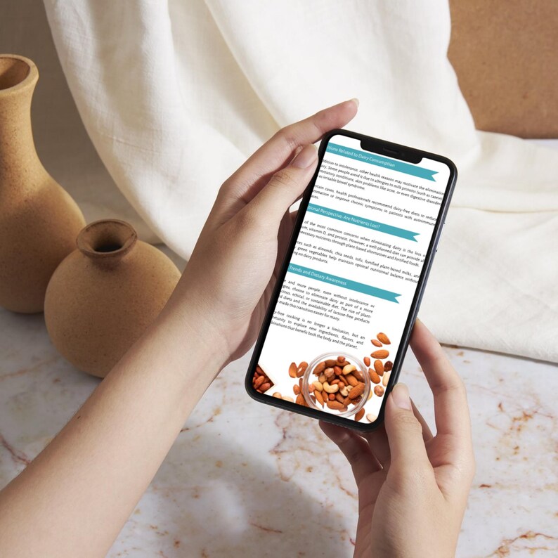 May include: A smartphone displaying text about nutrition and a bowl of mixed nuts. The phone is held by a person, with two decorative vases in the background. The image is well-lit, with a focus on the phone's screen.