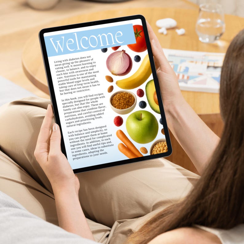 May include: A tablet displaying a recipe book with the title "Welcome." The screen features colorful images of fruits and vegetables, including a tomato, onion, banana, and avocado. The text discusses diabetes-friendly recipes.