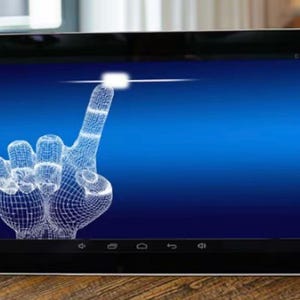 May include: A black tablet displays a blue gradient background with a wireframe hand pointing upwards. The hand is white and appears to be interacting with a glowing white square. The tablet is on a wooden surface.