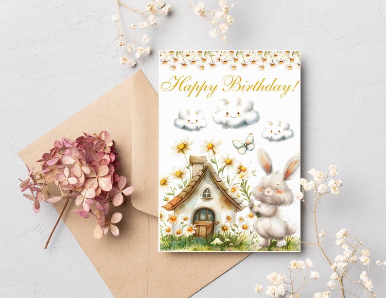 May include: A white bunny holding a bouquet of white flowers in front of a small cottage with a brown roof. The cottage is surrounded by white flowers and green grass. The background is white with three white clouds with smiley faces and the text "Happy Birthday!" in gold lettering.
