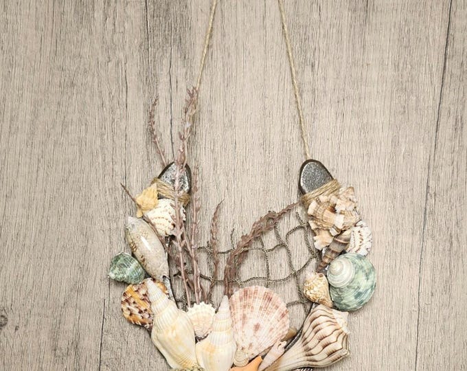 GO TO SHELL!.... Hand decorated used horseshoe features Florida seashells and old fishing net.