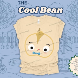 May include: A light tan t-shirt featuring a cartoon bean character with a blue bow tie and the text "The Cool Bean". The design is set against a blue background with a playground scene.