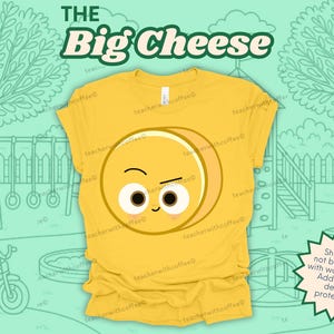 May include: Yellow t-shirt with a cartoon cheese graphic. The cheese has a slightly annoyed expression with a curved eyebrow and a blush. The text "THE Big Cheese" is above the graphic. The background shows a playground scene.