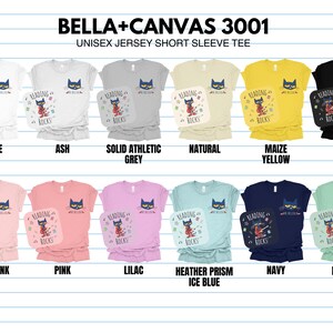 May include: A Bella + Canvas 3001 unisex jersey short sleeve tee in various colors, featuring a graphic of a cat reading a book with the text "Reading Rocks".