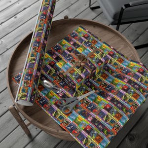 May include: A brown wooden tray with a colorful wrapping paper featuring a repeating pattern of vintage book covers. A small gift box wrapped in the same paper is on the tray. A roll of wrapping paper is also on the tray.