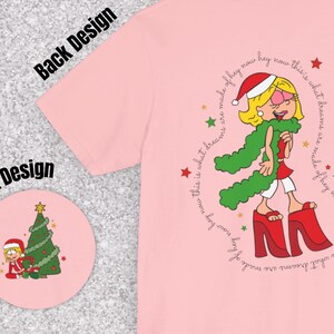 May include: Pink t-shirt with a cartoon illustration of a girl wearing a green scarf and red boots. The text "This is what dreams are made of hey now hey now this is what dreams are made of hey now hey now" is printed around the illustration.