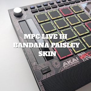 May include: An Akai MPC Live III with a bandana paisley skin. The skin has a black and pink paisley pattern, with black pads and buttons. The text "MPC LIVE III BANDANA PAISLEY SKIN" is displayed on the device.