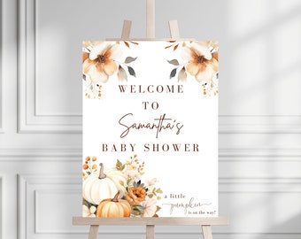 May include: Welcome to Samantha's Baby Shower sign with a fall theme. The sign features a white background with brown text and a watercolor illustration of pumpkins and flowers.