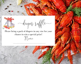 May include: A white card with the words "diaper raffle" in elegant script, accompanied by a watercolor illustration of crawfish and a pot. The card's text invites guests to bring diapers for a chance to win a prize. A platter of cooked crawfish is in the background.