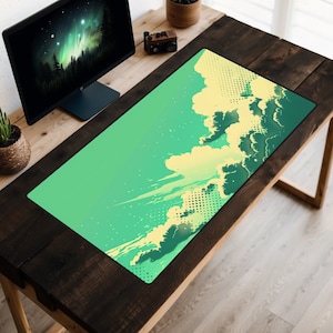 May include: A green and yellow desk mat with a cloud design. The mat is on a wooden desk with a computer monitor and a potted plant.