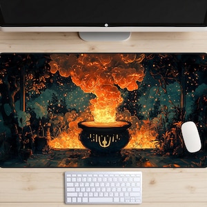 May include: A rectangular mouse pad featuring a fantasy scene with a cauldron emitting a large plume of orange flames. The background depicts a forest with trees and glowing lights. A white keyboard and mouse are visible.