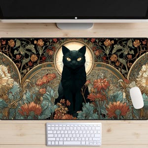 May include: A rectangular black mouse pad featuring a black cat with yellow eyes, surrounded by flowers and foliage in shades of orange, green, and gold. The design has an Art Nouveau style, with a keyboard and mouse visible.