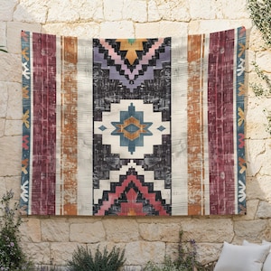 May include: A tapestry with a geometric pattern in shades of red, orange, blue, and white. The pattern is reminiscent of traditional Native American designs.