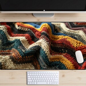 May include: A colorful knitted fabric with a wavy pattern in shades of red, orange, yellow, blue, green, and white.