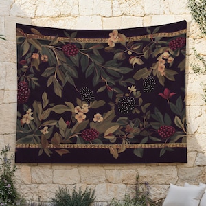 May include: A dark tapestry featuring a botanical design with berries, leaves, and flowers in shades of burgundy, green, and cream. The tapestry has a decorative border with gold accents. The overall theme is nature and home decor.