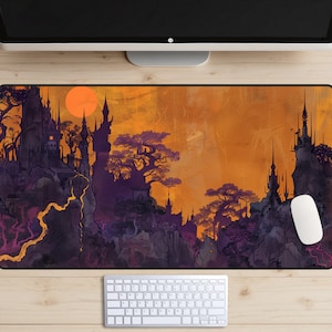 May include: A purple and black illustrated design of a castle on a cliff with a large orange sun in the background. The design is on a mouse pad.