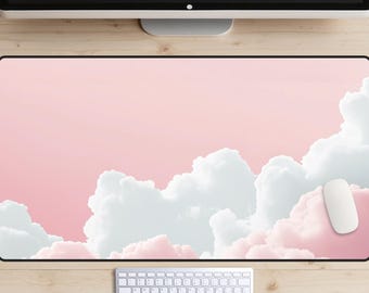 May include: A pink and white desk mat with a cloud design. The mat is on a wooden surface with a white keyboard and mouse.