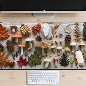 May include: A desk mat with a fall theme featuring mushrooms, leaves, and pine cones in shades of brown, orange, and green. The mat is made of a soft, textured material and is perfect for adding a touch of autumn to your workspace.