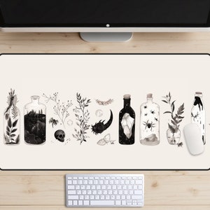 May include: A black and white illustrated design of a desk mat featuring a row of glass bottles filled with various objects, including a skull, a spider, a crystal, and a forest scene. The bottles are surrounded by small black and white illustrations of plants and leaves.