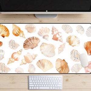 May include: A white desk mat with a pattern of seashells in various shades of brown and beige. The seashells are arranged in a random pattern and some are overlapping.