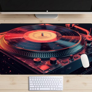 May include: A red and black turntable with a vinyl record on the platter. The turntable has a red and black design with a silver knob and a silver needle.