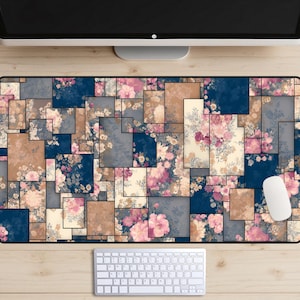 May include: A rectangular floral mouse pad featuring a patchwork design. The pattern includes squares of navy blue, tan, gray, and cream, each filled with pink and white flowers. A white keyboard and mouse are visible.