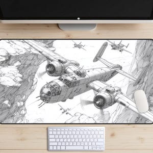 May include: Mouse mat featuring a black and white pencil-style illustration of a vintage bomber plane flying through a canyon. The artwork includes detailed depictions of the aircraft and other planes. A white mouse and keyboard are in the foreground.