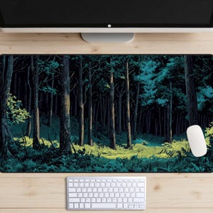 May include: A rectangular mouse mat depicting a forest scene with tall trees and a path. The colour palette includes dark greens, blues, and yellows, creating a moody, natural aesthetic. A white mouse and keyboard are visible.