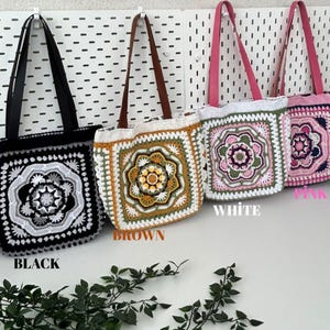 May include: Four crochet tote bags in black, brown, white, and pink, each with a square floral design. The bags have different colored straps and are displayed against a white background. The word "BLACK", "BROWN", "WHITE", and "PINK" are written below each bag.