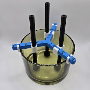 May include: Three black rods with white clips are inserted into a clear glass jar. The clips have blue markings with measurements in inches: 6 in, 4 in, 2 in.