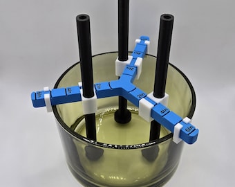 May include: Three black rods with white clips are inserted into a clear glass jar. The clips have blue markings with measurements in inches: 6 in, 4 in, 2 in.