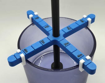 May include: A blue and white 3D printed tool for measuring the depth of a container. The tool has four arms that extend out from a central rod. Each arm has a ruler marked in inches. The tool is sitting in a clear glass container.