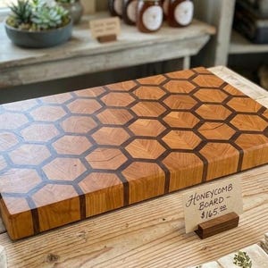 May include: A set of three ceramic mugs with a speckled, matte finish. The mugs are in shades of cream, light gray, and dark gray. Each mug has a simple, minimalist design, perfect for coffee or tea.