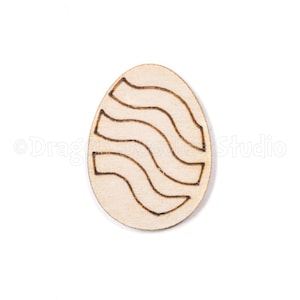 May include: A wooden egg-shaped ornament with a wavy line design carved into the surface.