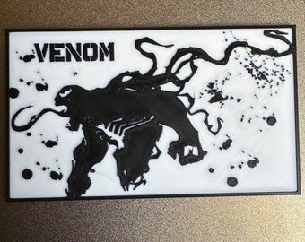 Venom from spider man wall/desk plate.         7 3/4” x 4 1/2” x 3/16” thick. For hanging on your wall or standing up on a desk.