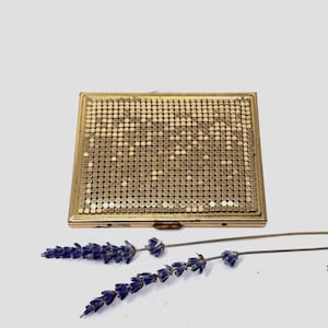 May include: A white ceramic mug with a black handle and the text "But First, Coffee" in a handwritten style. The mug is on a white surface. The mug is approximately 4 inches tall.