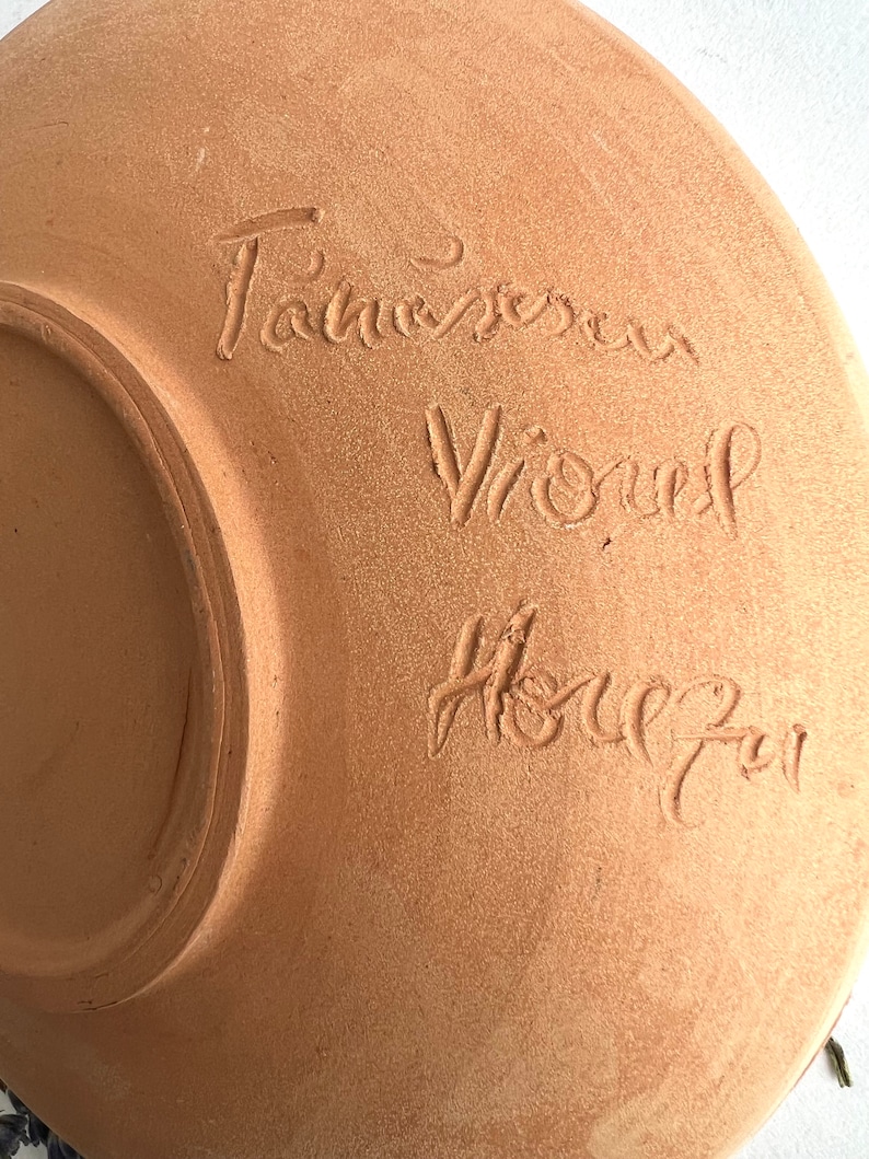 May include: A terracotta plate with the inscription "Tannereau Vionnet House" in cursive.