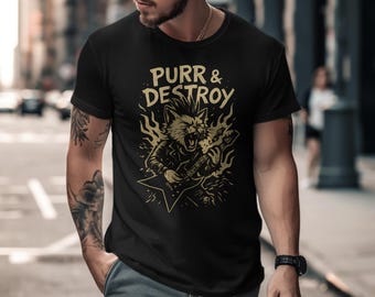 Puede incluir: Camiseta negra con una ilustración dorada de un gato tocando la guitarra eléctrica. El texto "Purr & Destroy" está encima del dibujo del gato. La camiseta es de cuello redondo y tiene mangas cortas.