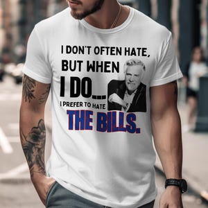 May include: White t-shirt with the text "I DON'T OFTEN HATE, BUT WHEN I DO... I PREFER TO HATE THE BILLS." The shirt features a black and white image of a man. The text is in black and red and blue.