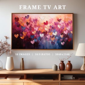 May include: A framed painting of a colorful abstract design with hearts in shades of pink, purple, blue, and orange. The painting is displayed on a wooden shelf with decorative vases and books.