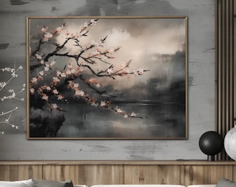 May include: A framed landscape painting depicts a serene scene with a blossoming tree branch over a body of water. The artwork features soft, muted tones of gray, beige, and pink, creating a calming atmosphere. The painting is displayed above a wooden cabinet and a light-colored sofa.