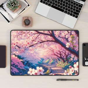 May include: A pink and white mousepad with a scenic image of a pathway lined with cherry blossom trees. The trees are in full bloom and the pathway leads up a hill.
