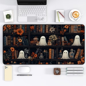 May include: A black and white mouse pad with a dark background featuring a bookshelf filled with books and flowers. There are white ghosts floating in front of the bookshelf.