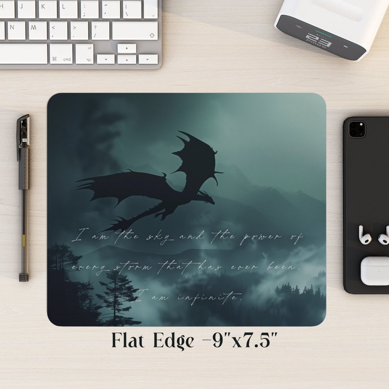 May include: A dark green mousepad with a silhouette of a dragon flying over a misty mountain range. The text "I am the sky and the power of every storm that has ever been. I am infinite." is printed on the mousepad. The mousepad is 9 inches by 7.5 inches.