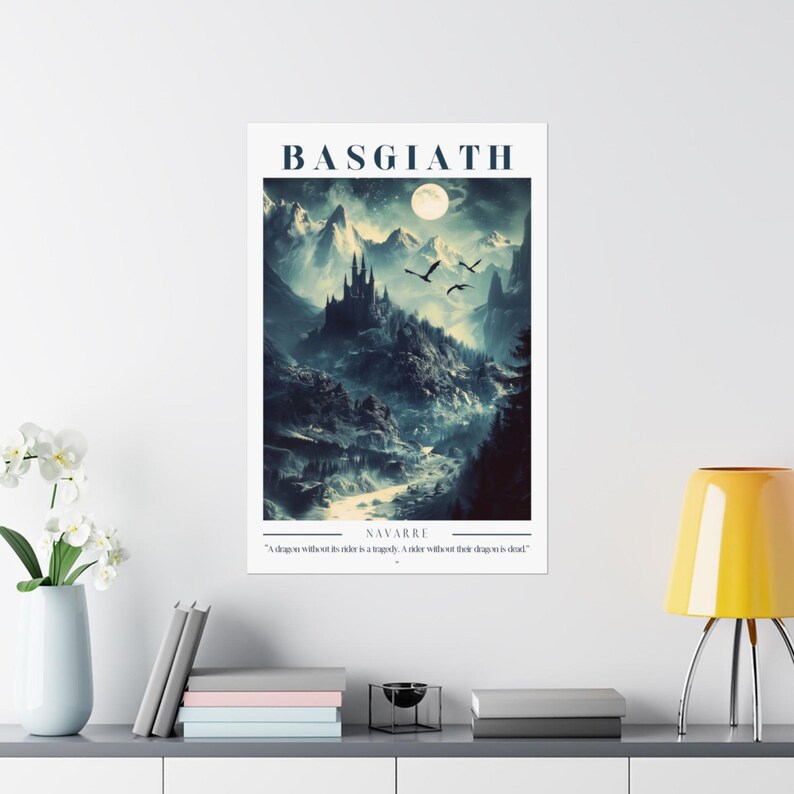 May include: A dark blue and white poster with the text "BASGIATH NAVARRE" and a quote: "A dragon without its order is a tragedy. A rider without their dragon is dead." The poster features a digital illustration of a dark castle on a mountain with a full moon in the sky and three birds flying overhead.