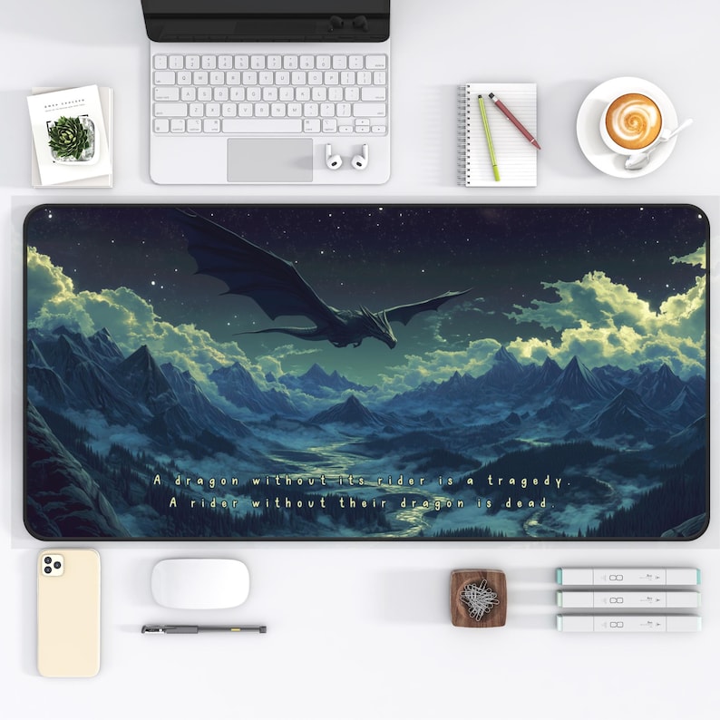 May include: A black and blue mousepad with a dark blue background and a black dragon flying over a mountain range. The text "A dragon without its rider is a tragedy. A rider without their dragon is dead." is printed on the mousepad.