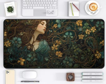 May include: A large, rectangular mouse pad featuring a woman with long brown hair and a teal dress, surrounded by yellow and teal flowers and vines. The pad is on a white desk with a keyboard, phone, and coffee cup.
